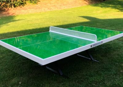 Forte green ping-pong table in a park.